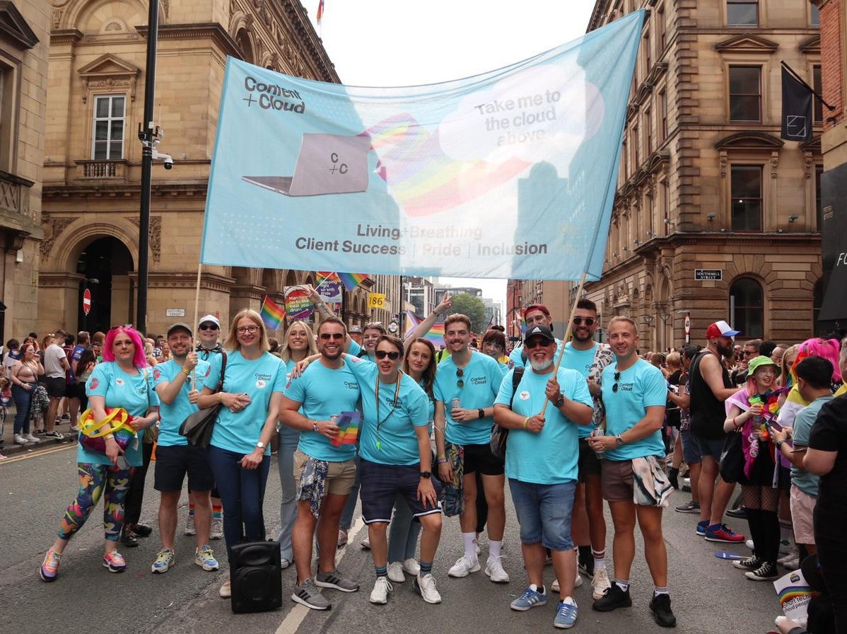 group of people holding banner supporting pride